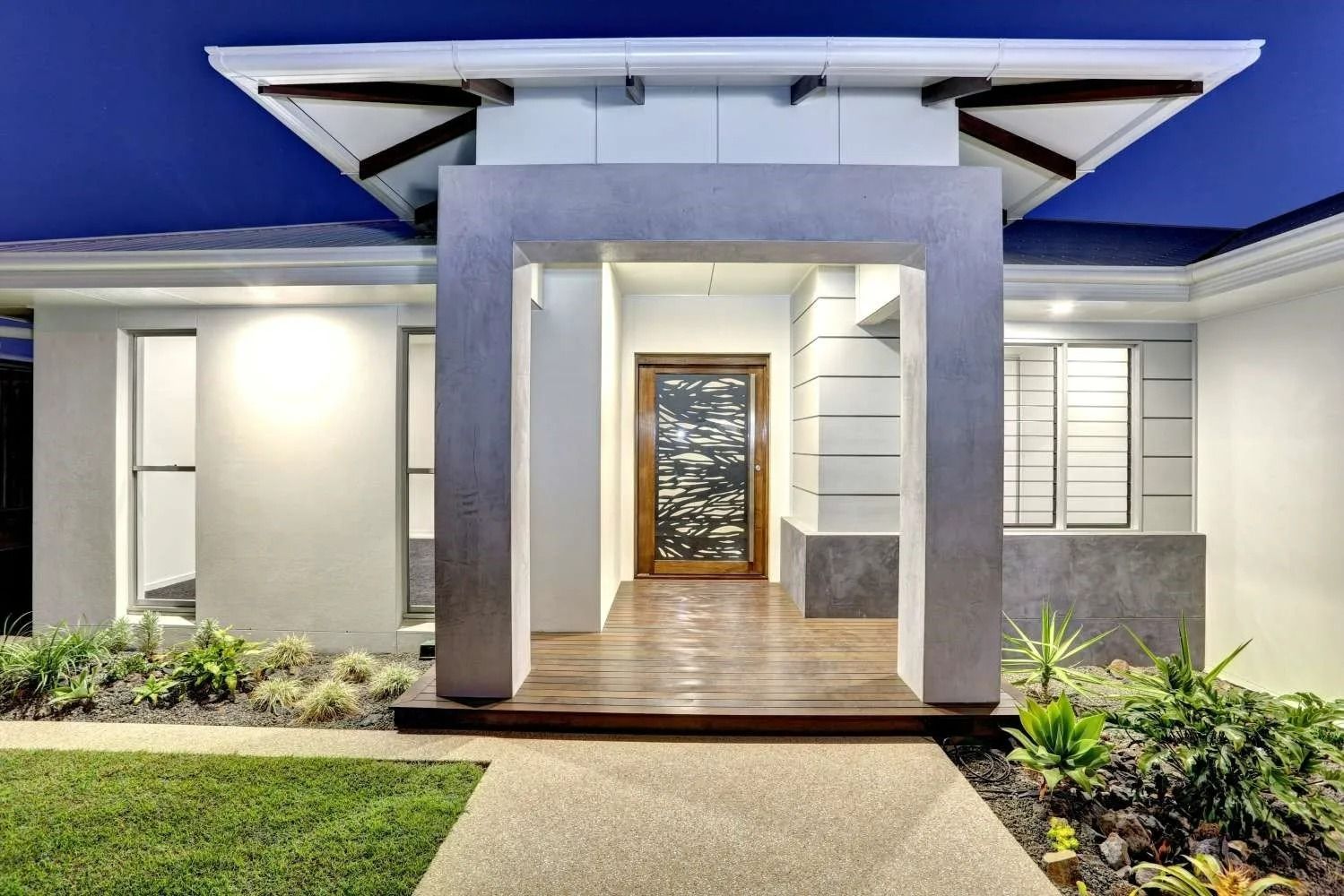 Front View of a Modern House Entrance With a Lit Porch — Gatley Building Design in Bundaberg East, QLD