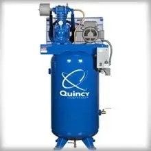 A blue air compressor is sitting on top of a white surface.