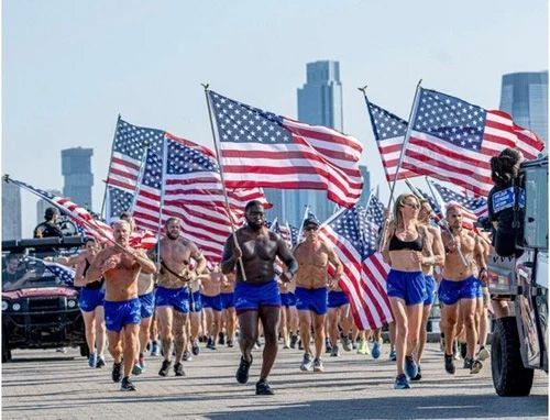Runners carrying large American flags during a patriotic parade Runners carrying large American flags during a patriotic parade