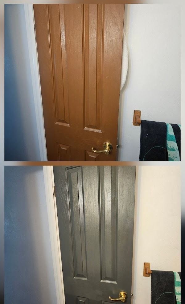 Door painted brown then gray in bathroom, with towel rack and towels.