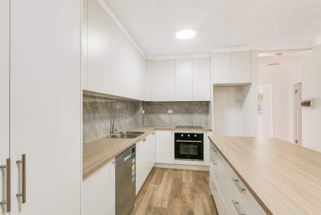 White Kitchen with Wooden Countertops— Zero 21 Fit-Outs & Joinery: Kitchen Renovation Gold Coast in Molendinar, QLD