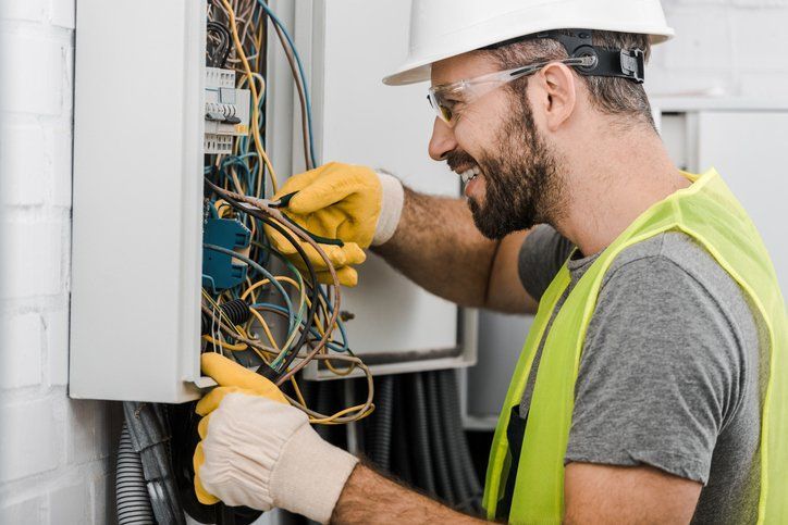 Electrical Technician Working on a Switchboard