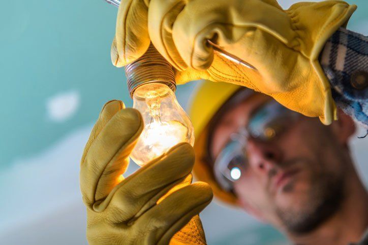 Electrician Fixing the Light Bulb