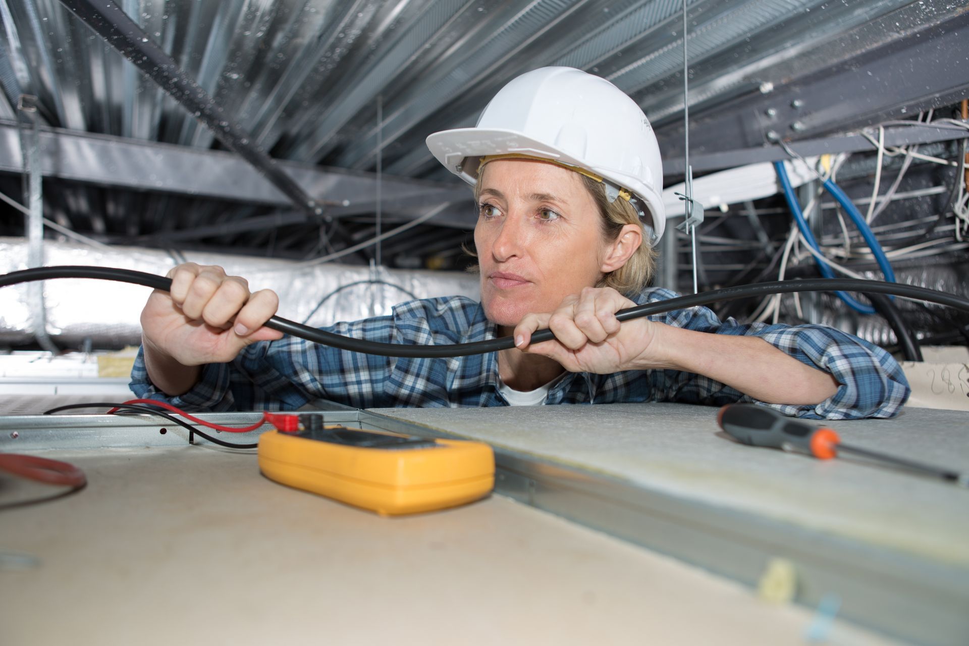 Electrician Measuring the Voltage of Fusebox Switches