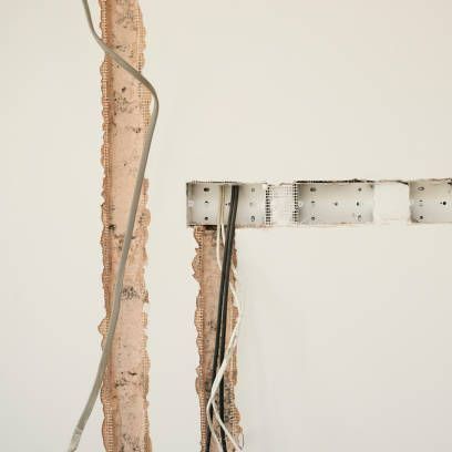 There are a lot of wires coming out of the wall.