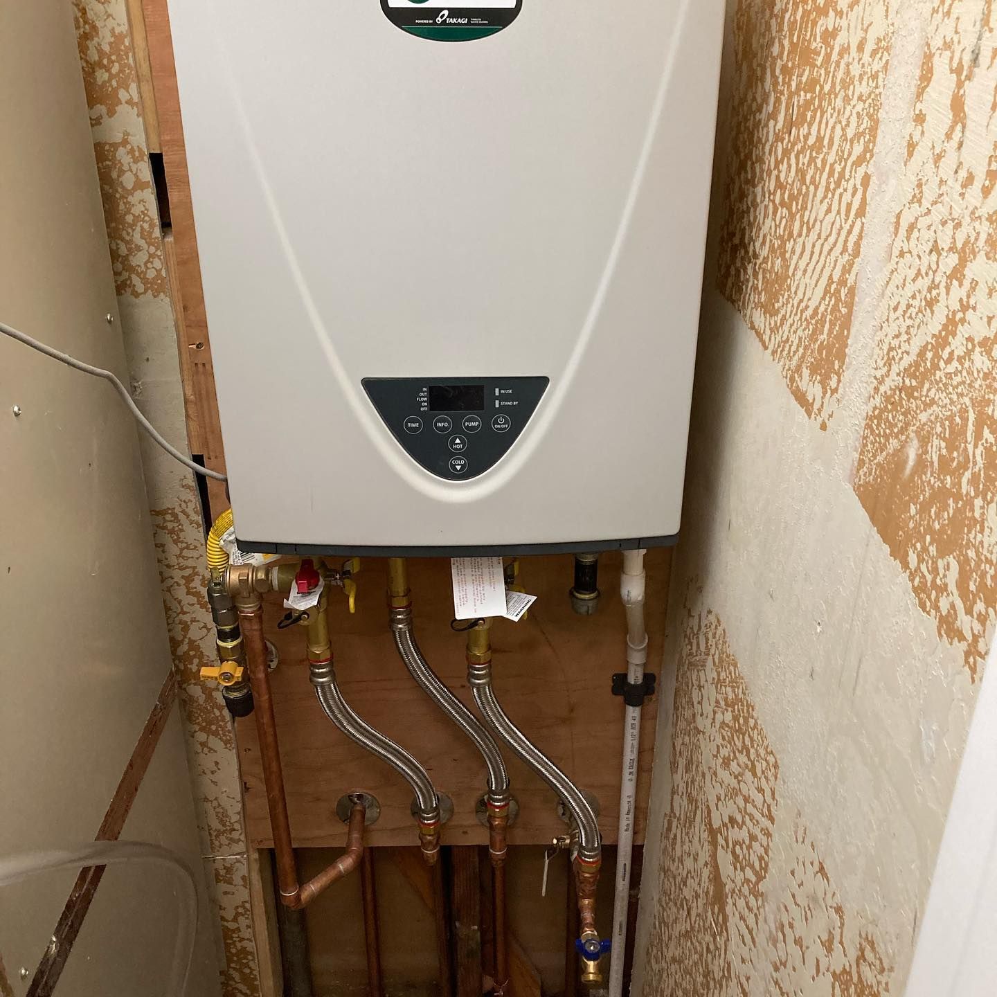 a white water heater is mounted on a wall