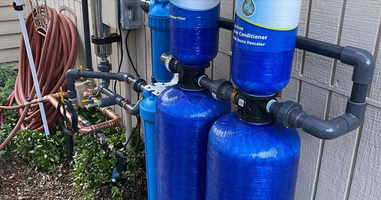 a couple of blue bottles sitting next to each other on the side of a building .