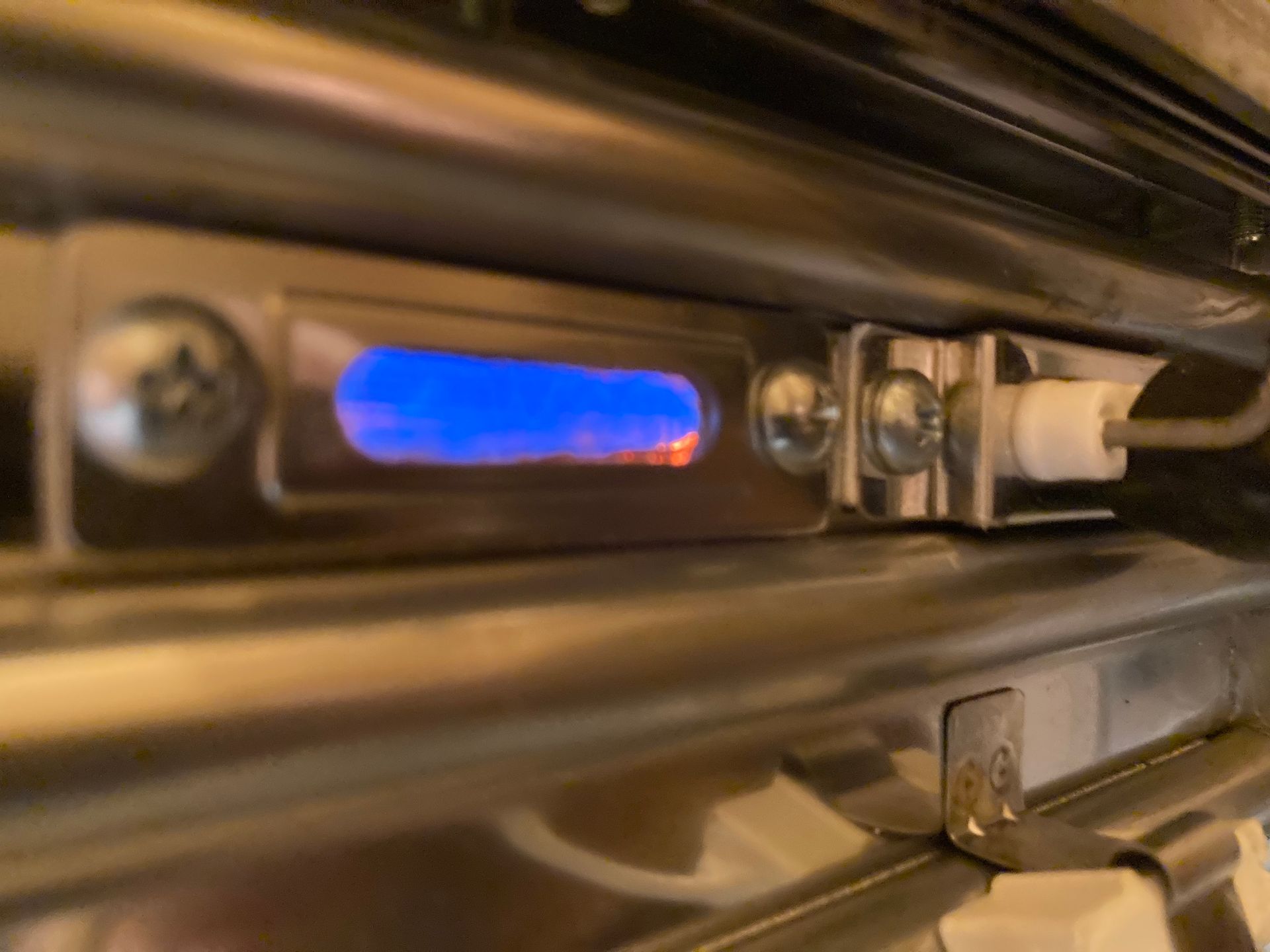a close up of a dishwasher with a blue light on it .