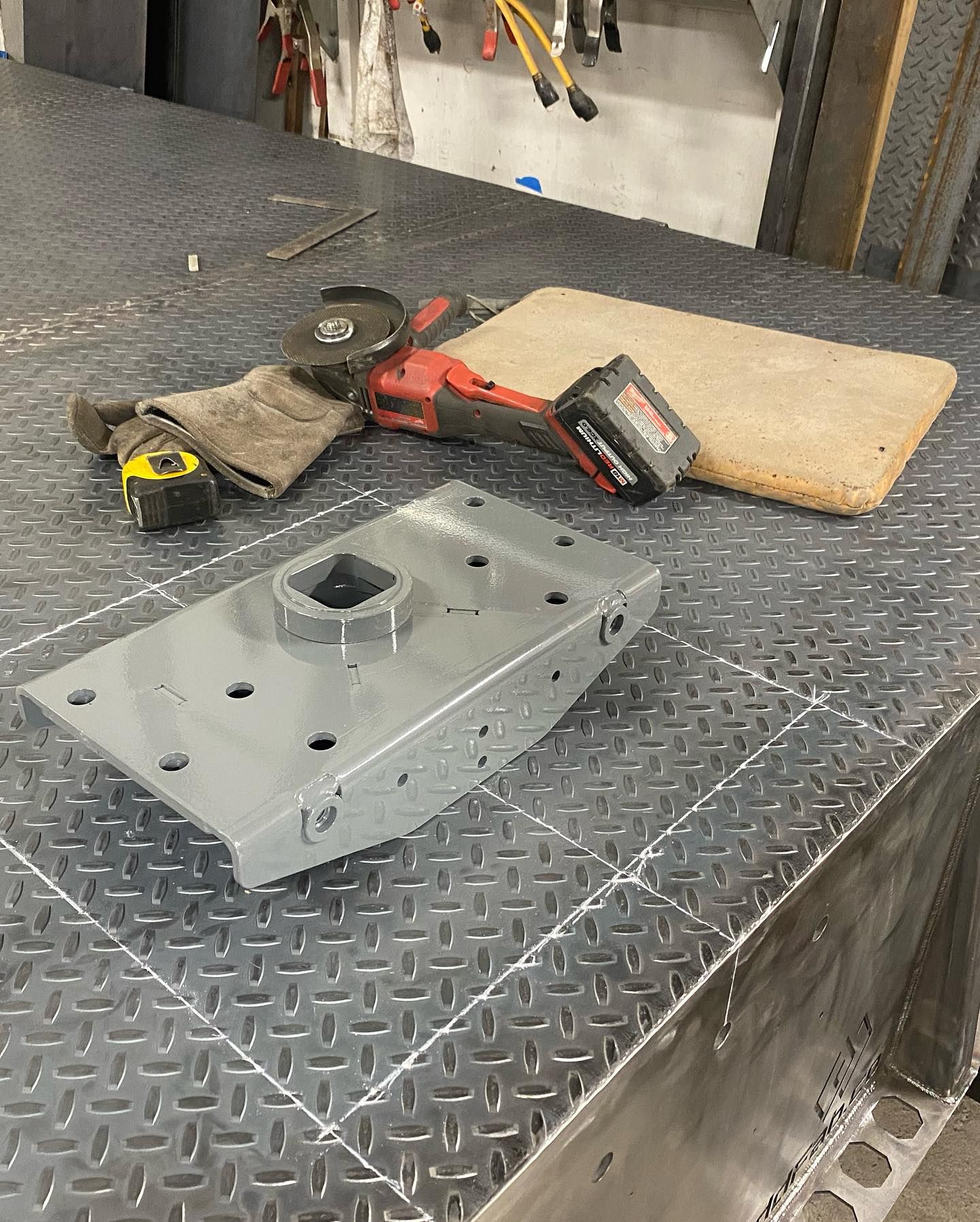 a piece of metal is sitting on top of a metal table .