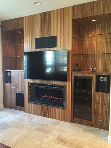 A living room with a fireplace and a flat screen tv.