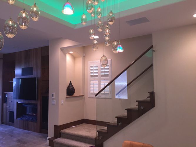 A living room with stairs leading up to the second floor