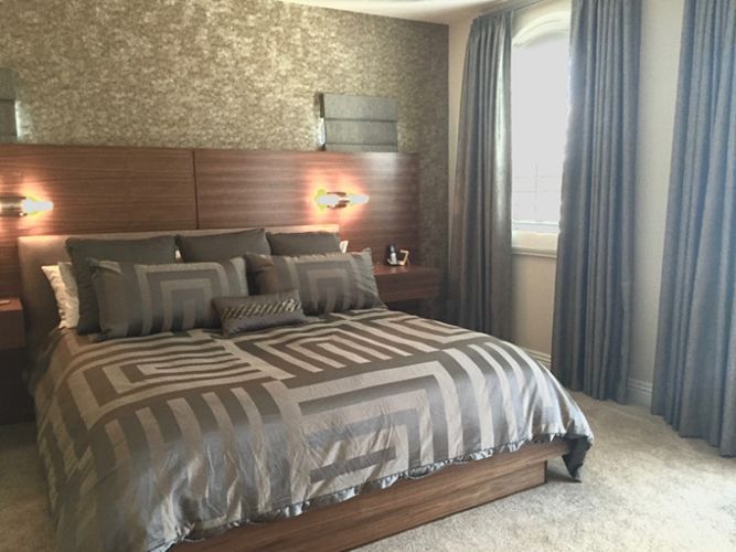 A bedroom with a large bed and a window.