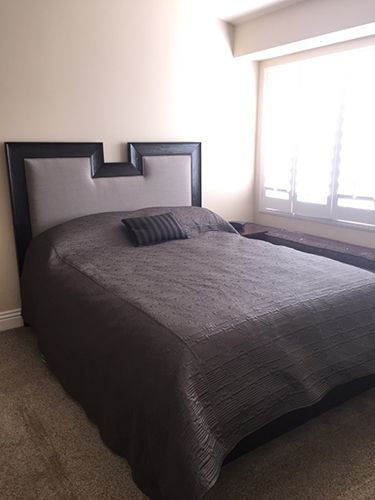 A bedroom with a large bed and a window.