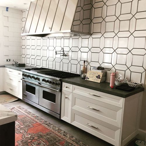 A kitchen with stainless steel appliances and white cabinets