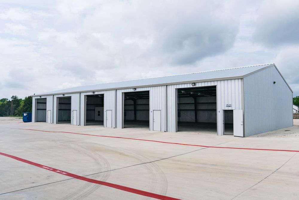 A large empty warehouse with a metal roof