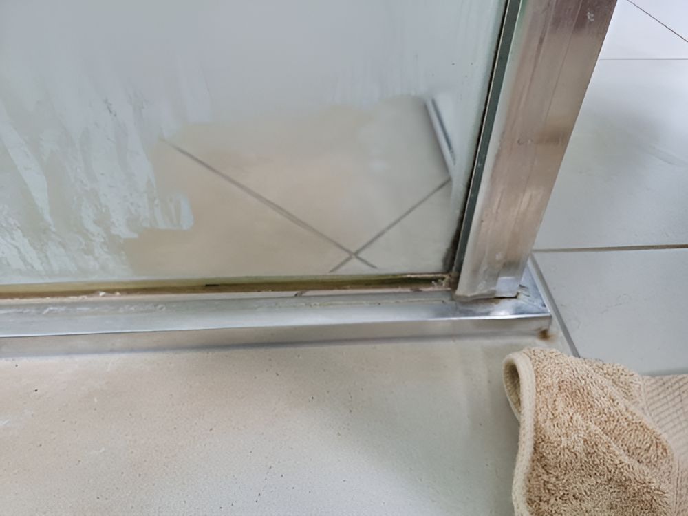 A Towel Is On The Floor Next To A Shower Door — A1 Cleaner Carpets N Homecare In Atherton, QLD