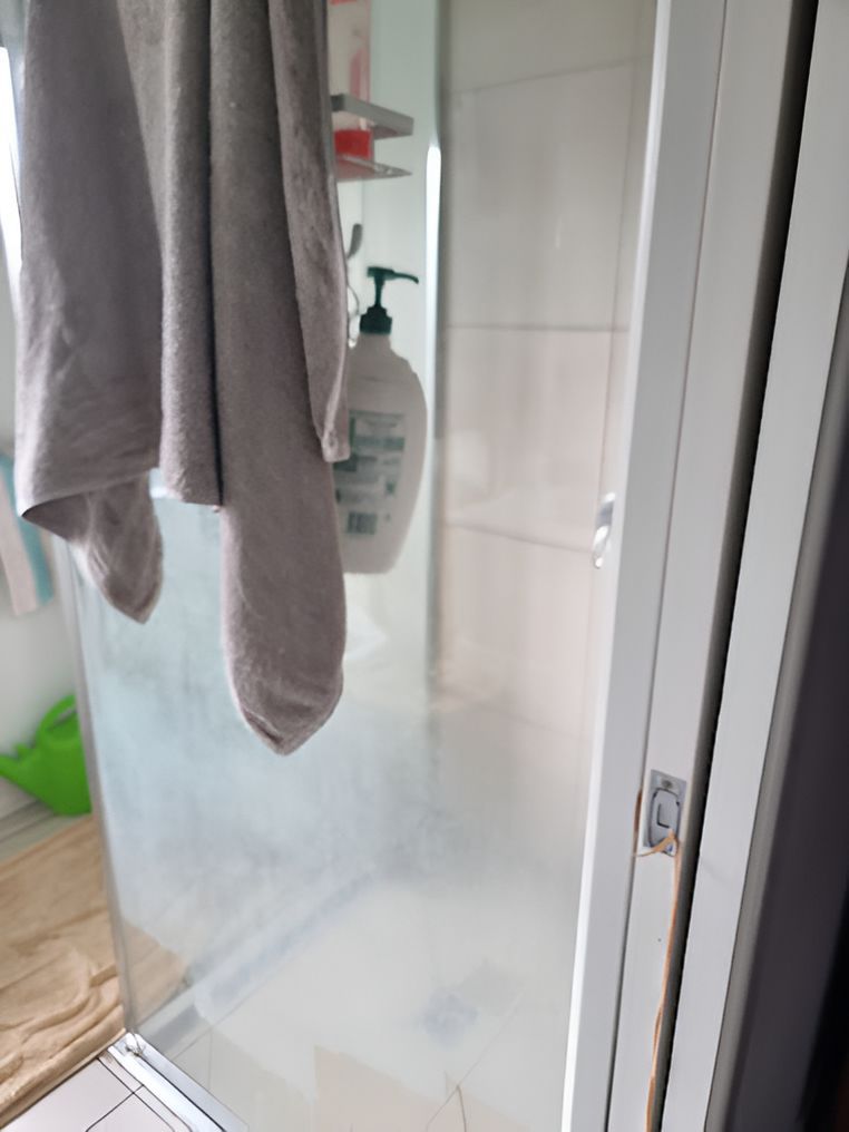 A Towel Is Hanging From A Shower Door In A Bathroom — A1 Cleaner Carpets N Homecare In Atherton, QLD