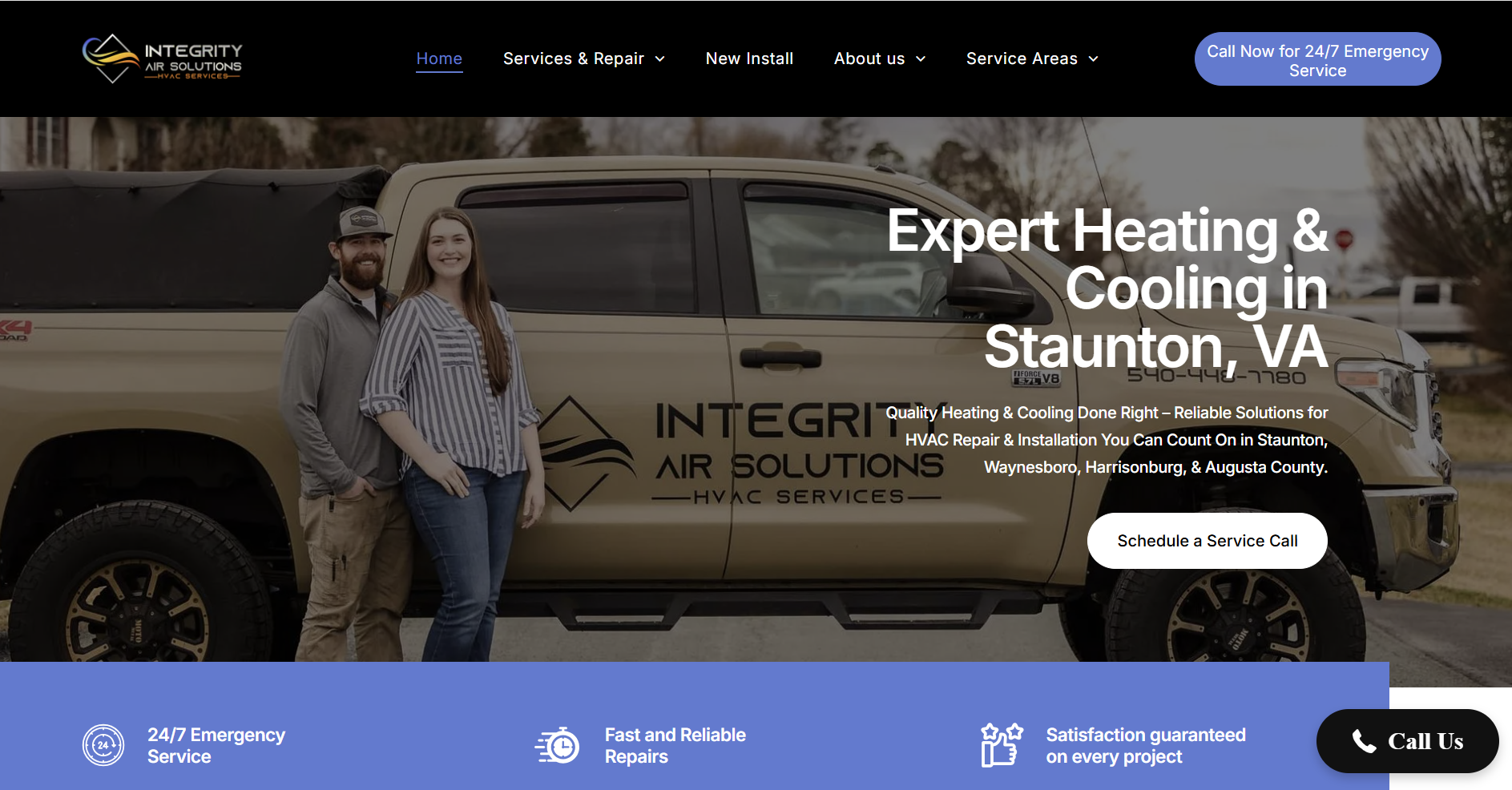 A man and a woman are standing in front of a truck.