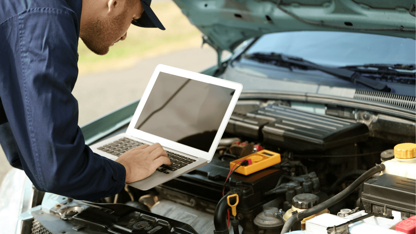 A mechanical technician doing a diagnostic scan. 
