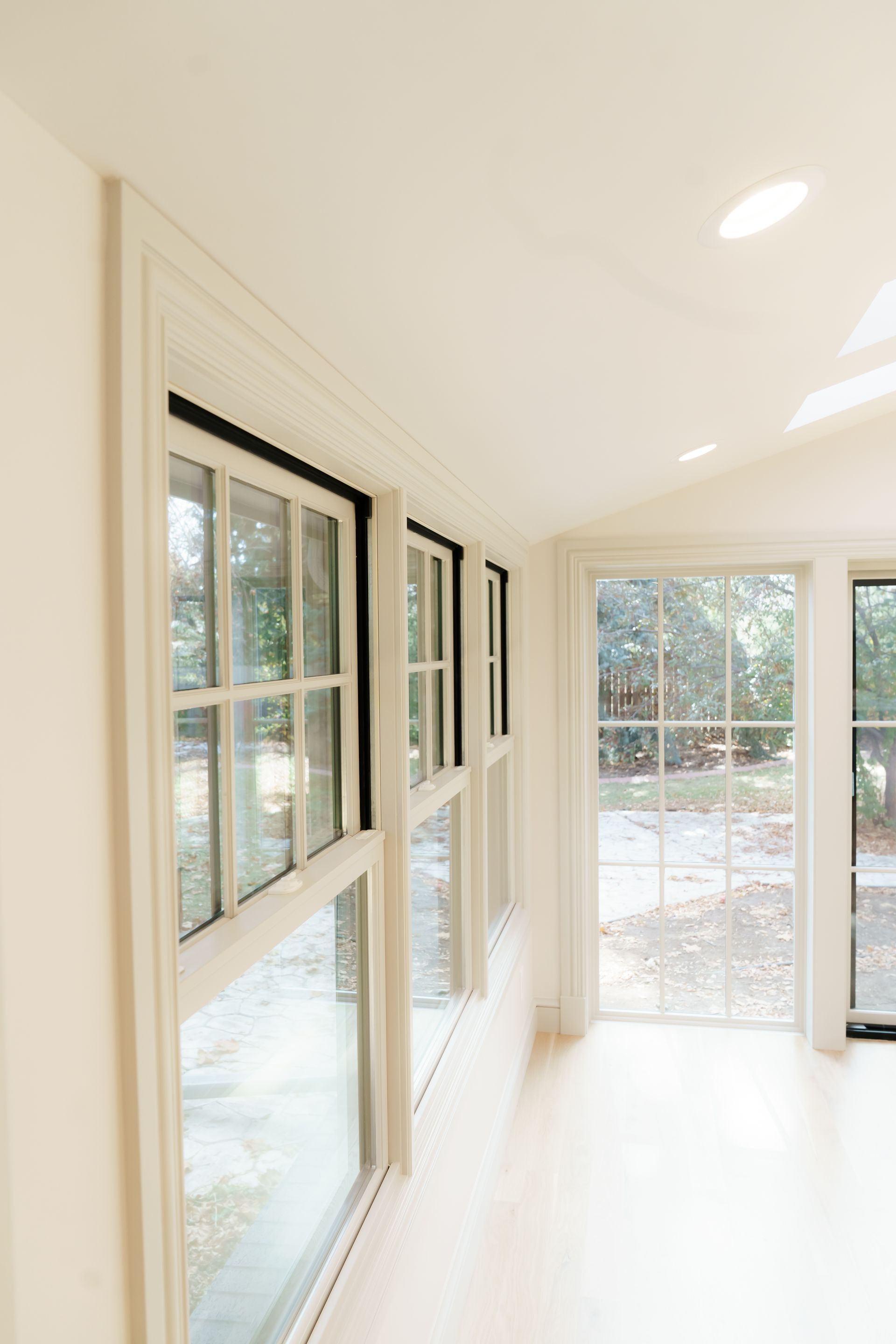 A room with a lot of windows and a ceiling light.