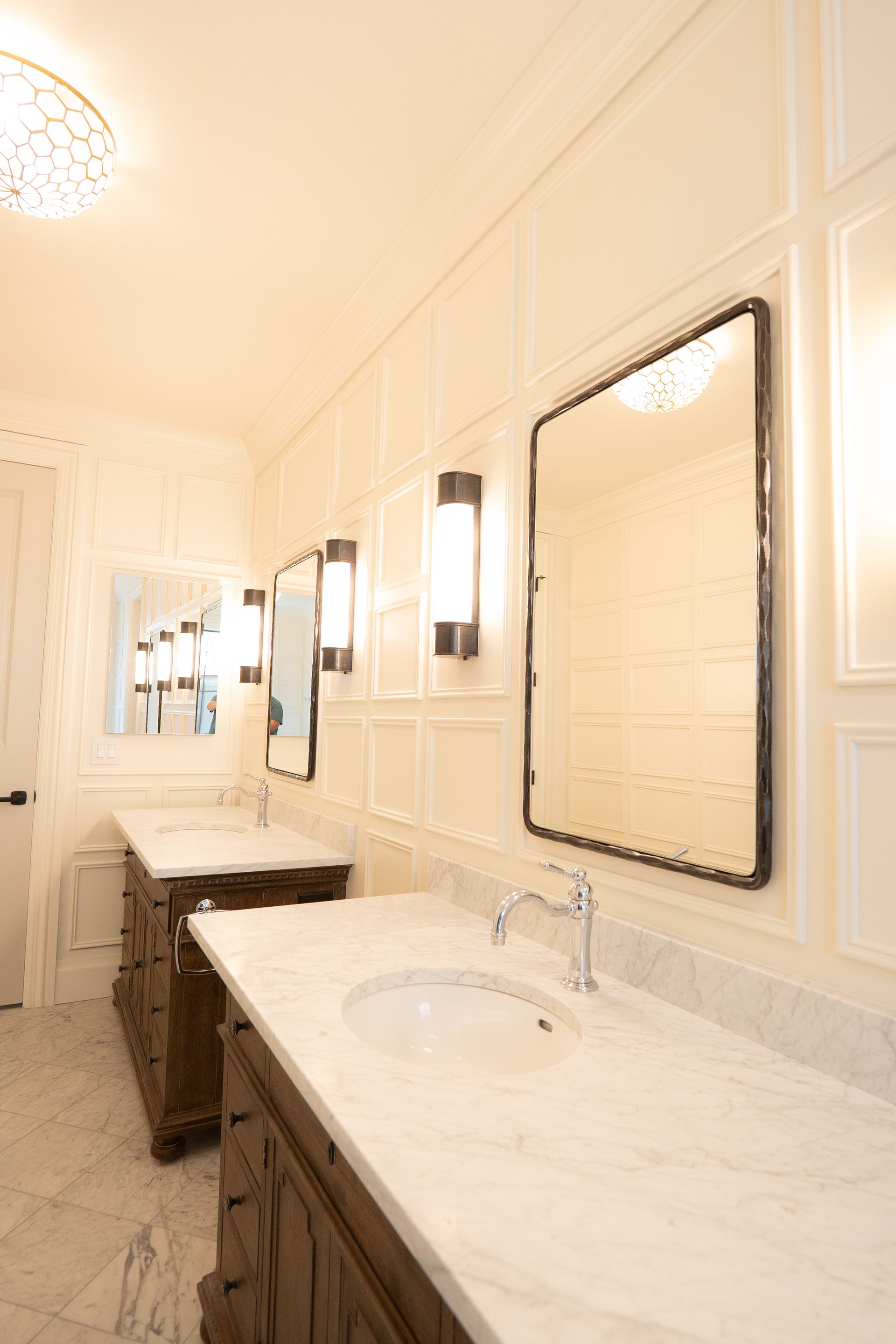 A bathroom with two sinks and two mirrors.