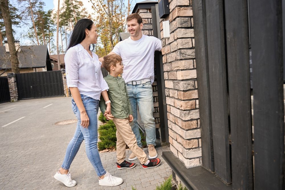 A family is walking in front of a brick building.