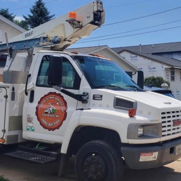 White utility bucket truck parked on a sunny street, with an extended boom and company logo on the door