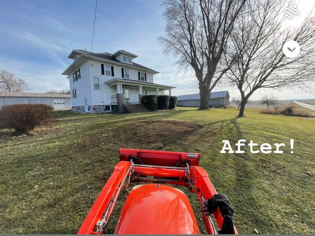 Red tractor view of a white house with bare trees and a river on a grassy hill, labeled “After!”