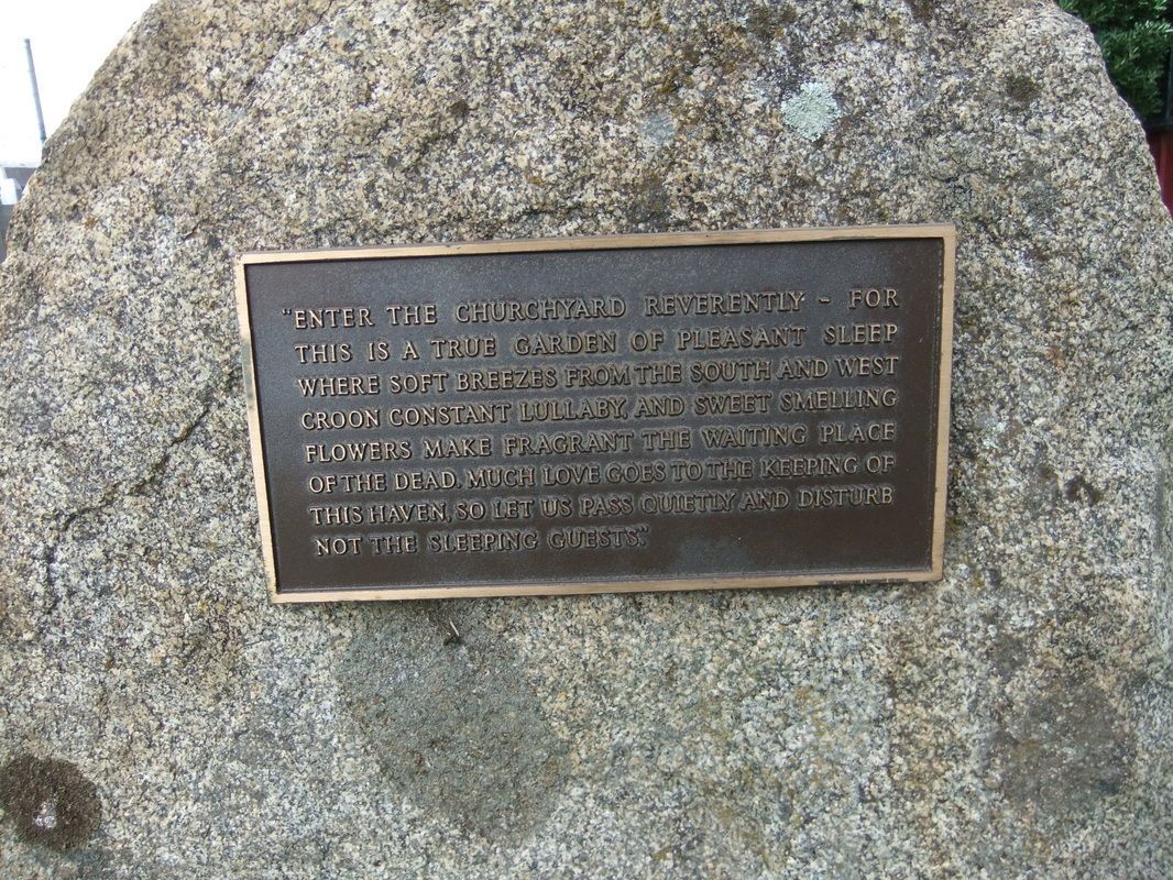 A large rock with a plaque on it.- Memorial Garden - St Paul's Frankston