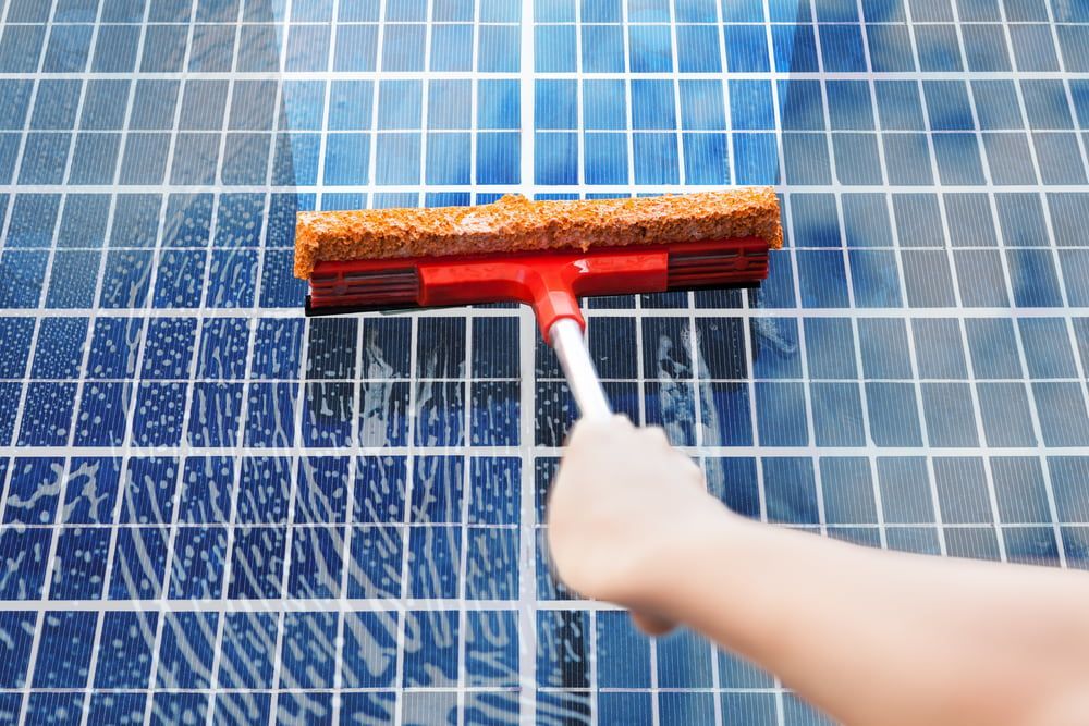 Hand Washing A Solar Panel — Ausmade Services Pty Ltd in Chapel Hill, QLD