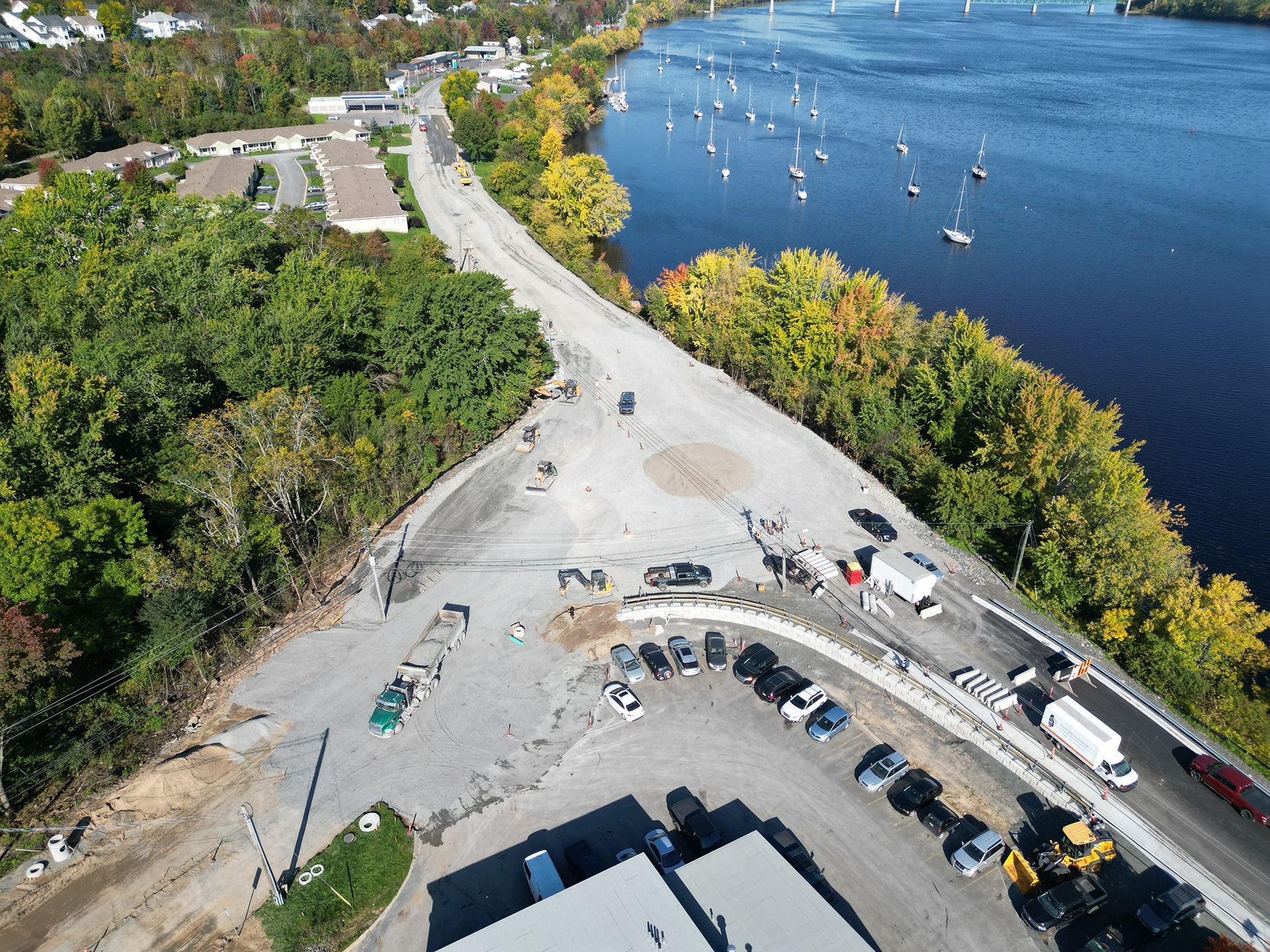 An aerial view of a parking lot next to a river
