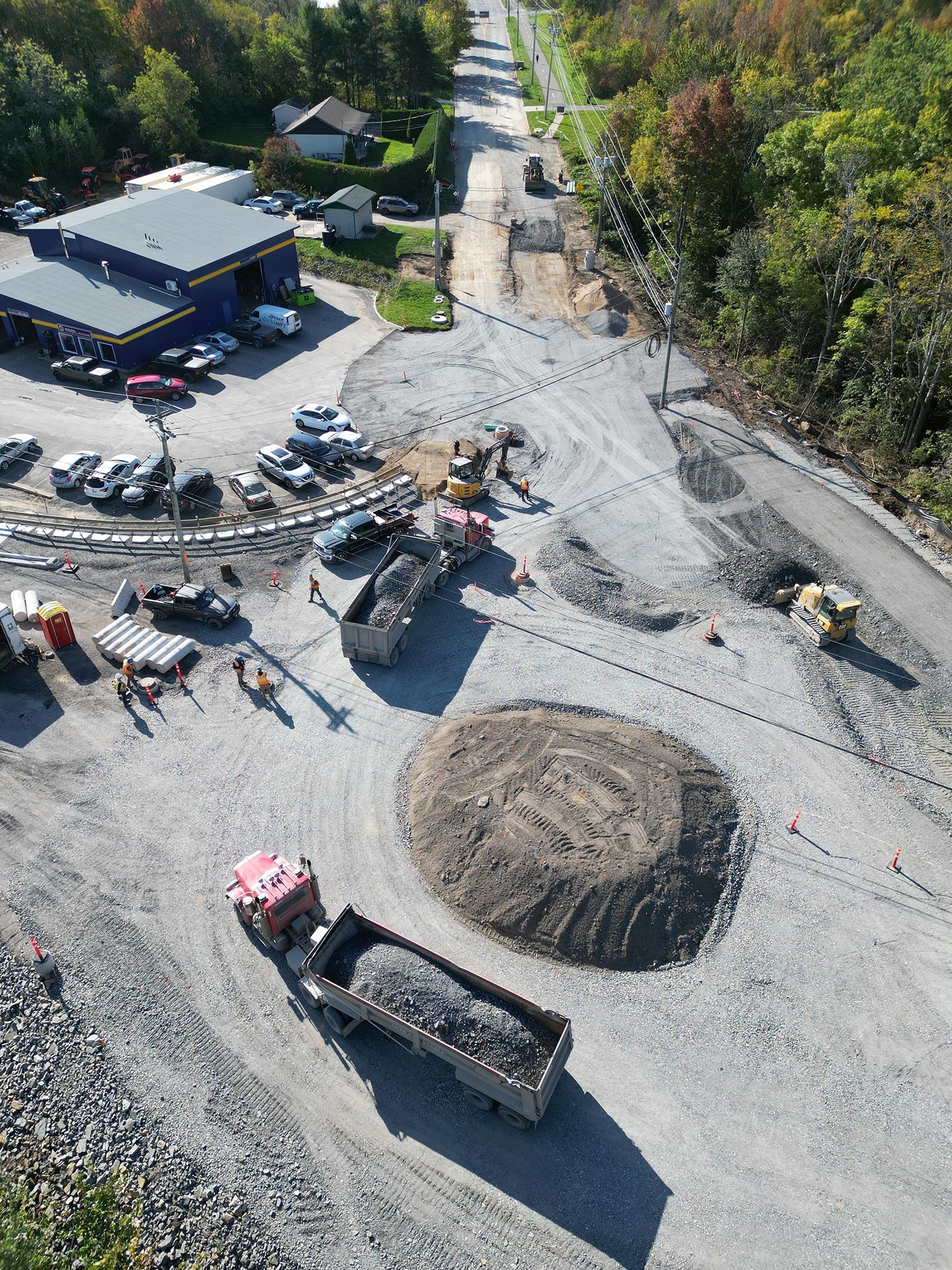 An aerial view of a construction site with trucks and machinery.