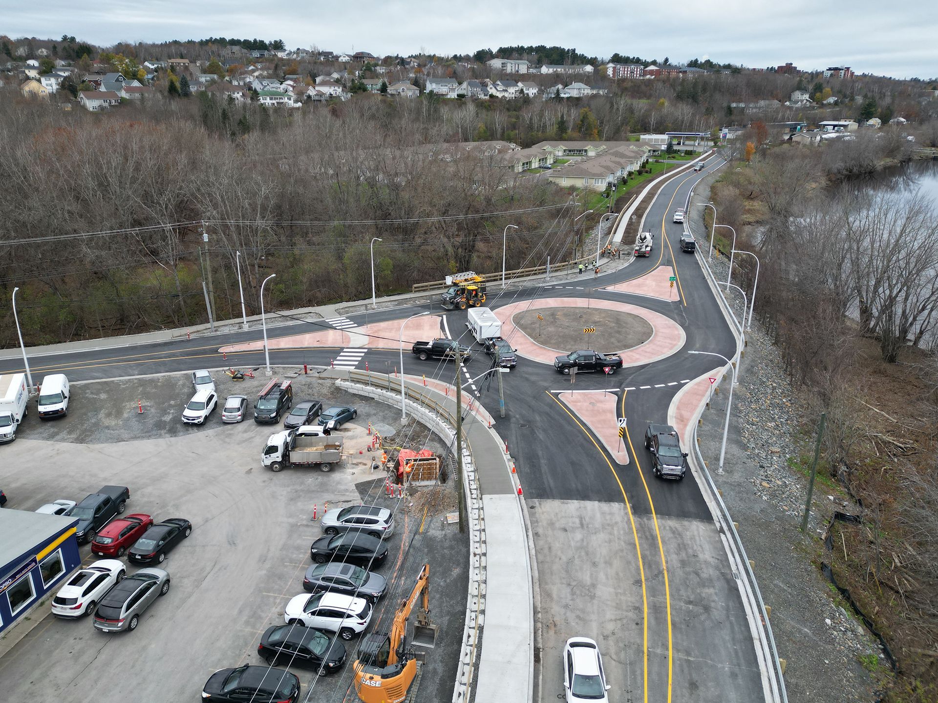 An aerial view of a roundabout and a parking lot