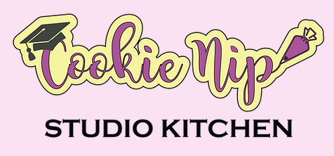 Logo for Cookie Nip Studio Kitchen featuring text in purple script with a graduation cap and icing piping bag.