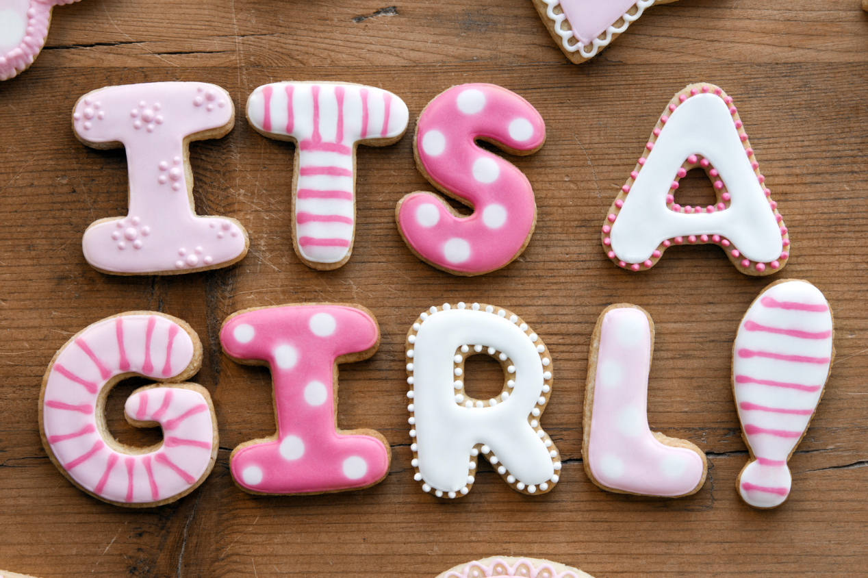 Sugar cookies shaped like letters and a semicolon arranged to spell out