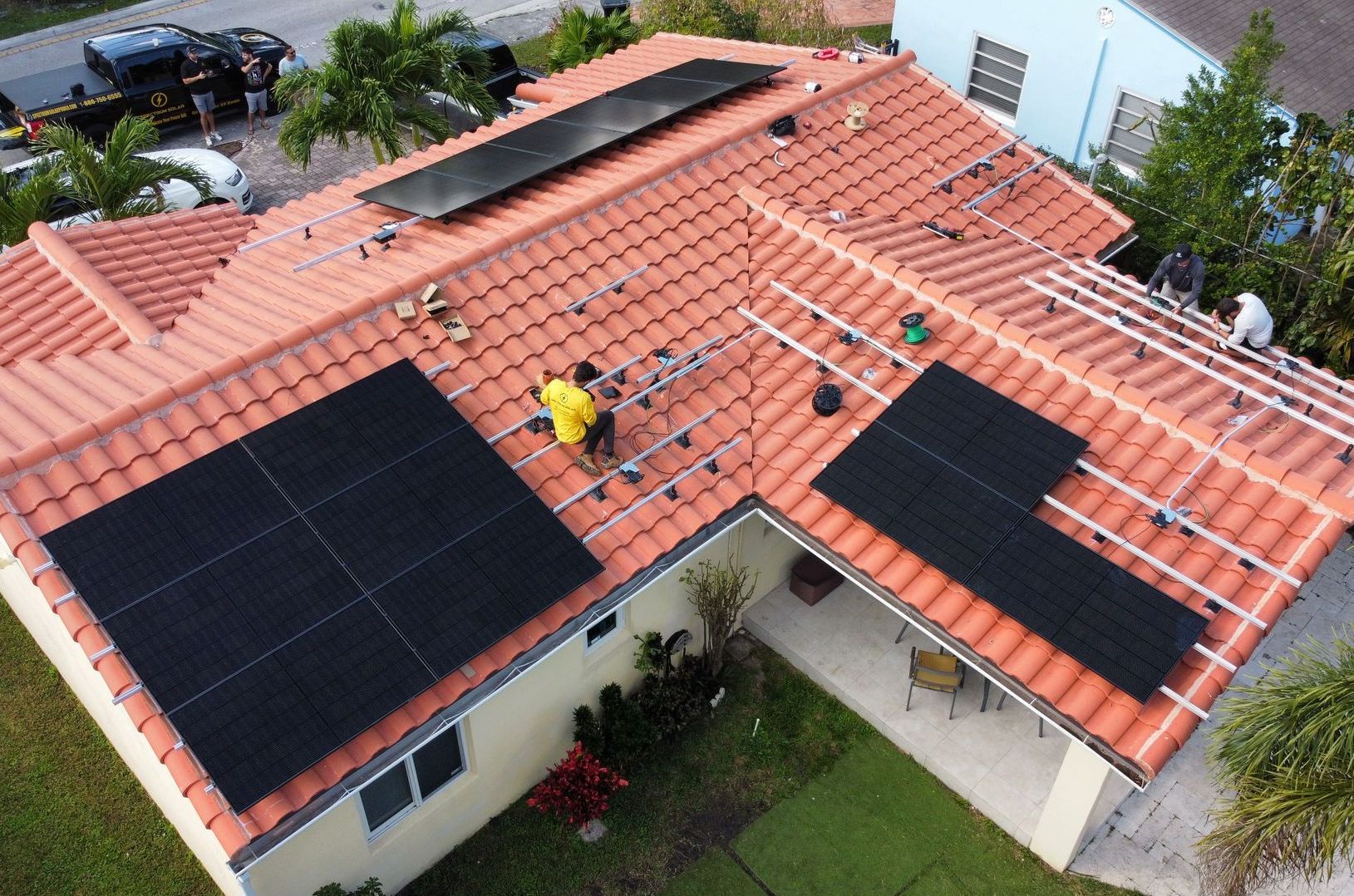 An aerial view of a house with solar panels on the roof
