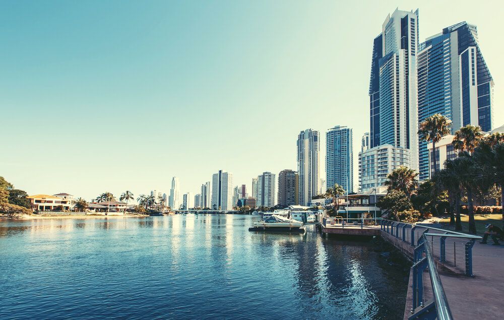 A City Skyline with A Body of Water in The Foreground — Goldspark GC Electrical in Broadbeach, QLD