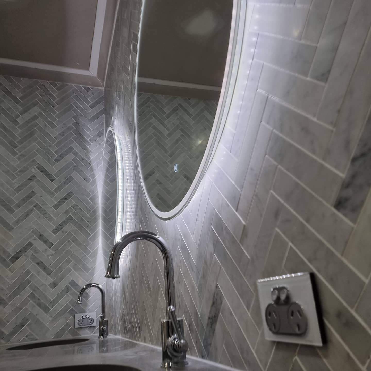 A Bathroom with A Sink and A Mirror on The Wall — Goldspark GC Electrical in Burleigh Waters, QLD
