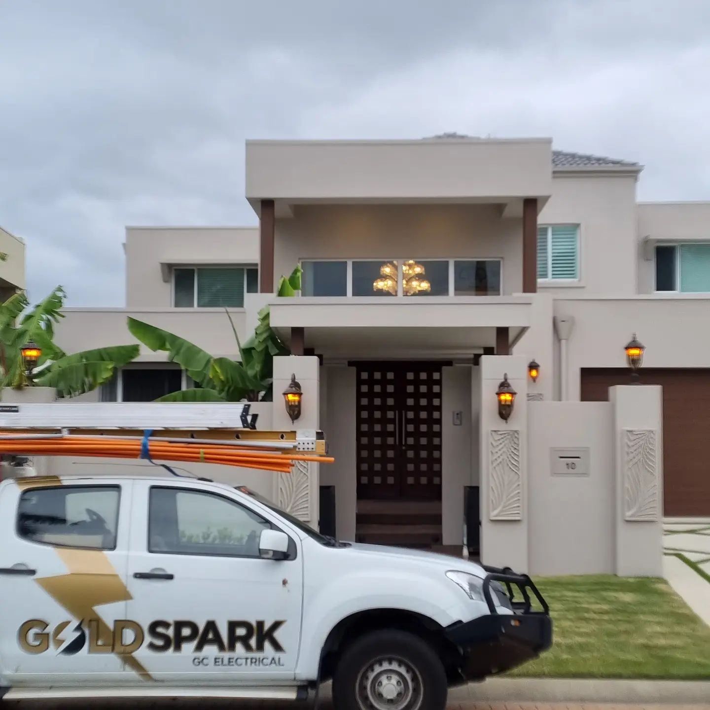 A Goldspark Truck Is Parked in Front of A House — Goldspark GC Electrical in Burleigh Waters, QLD