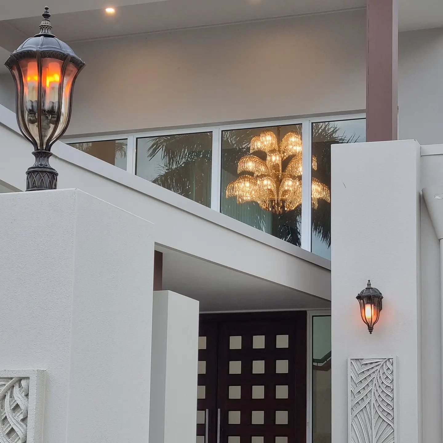 A Lamp on The Side of A Building Is Lit Up — Goldspark GC Electrical in Burleigh Waters, QLD
