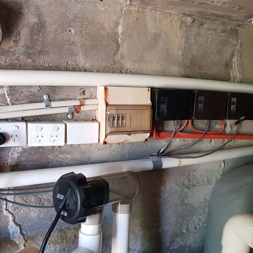 A Bunch of Electrical Wires Are Hanging from A Wall — Goldspark GC Electrical in Burleigh Waters, QLD