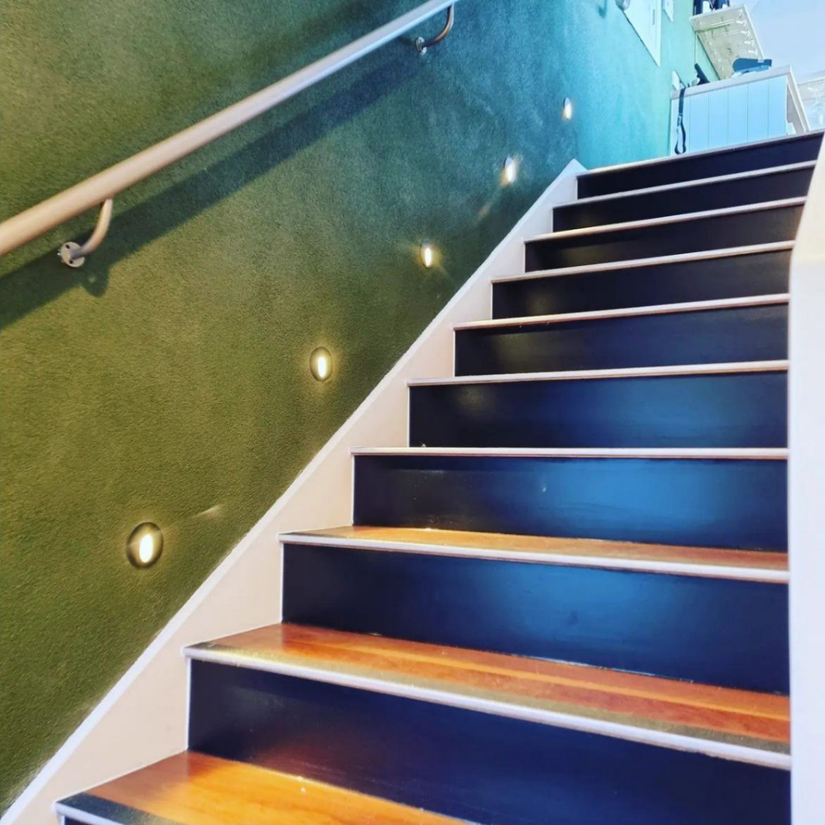 A Set of Stairs with A Green Wall Behind Them — Goldspark GC Electrical in Burleigh Waters, QLD