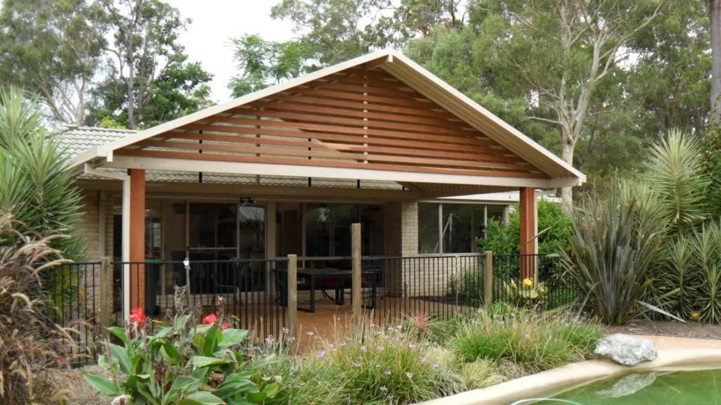 A House with A Covered Porch and A Pool in Front of It — Manning Valley Patios in Cundletown, NSW