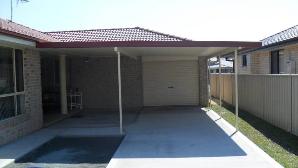 A Brick House with A Carport Underneath It — Manning Valley Patios in Cundletown, NSW