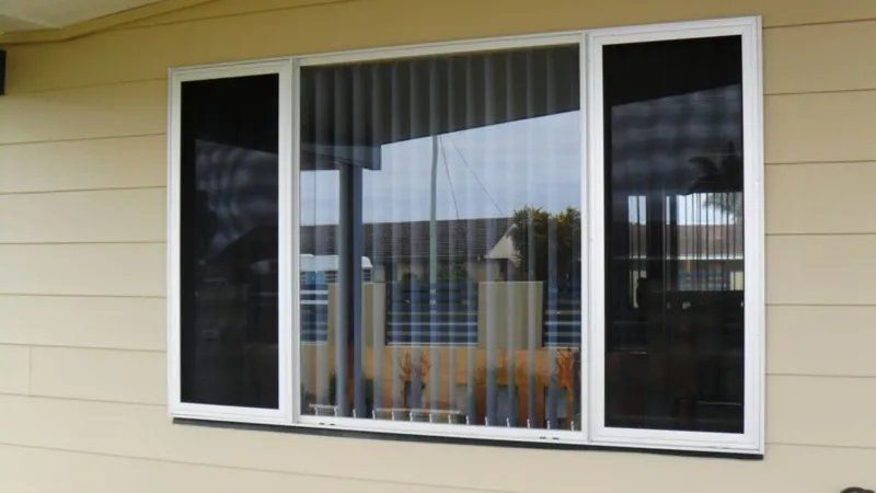 A Window with Blinds on It Is on The Side of A House — Manning Valley Patios in Nabiac, NSW