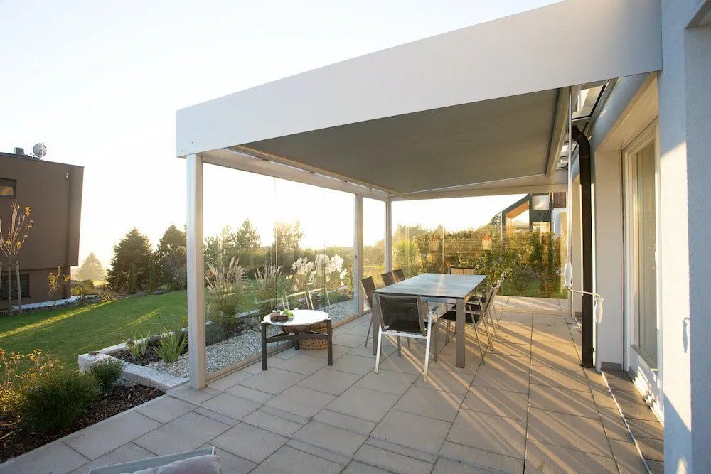 A Patio with A Table and Chairs Under a Pergola — Manning Valley Patios in Cundletown, NSW