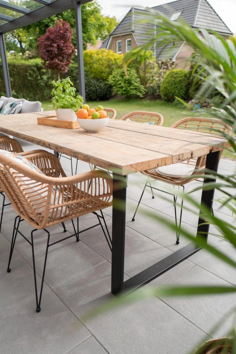 A Wooden Dining Table with Wicker Chairs on A Patio — Manning Valley Patios in Forster, NSW