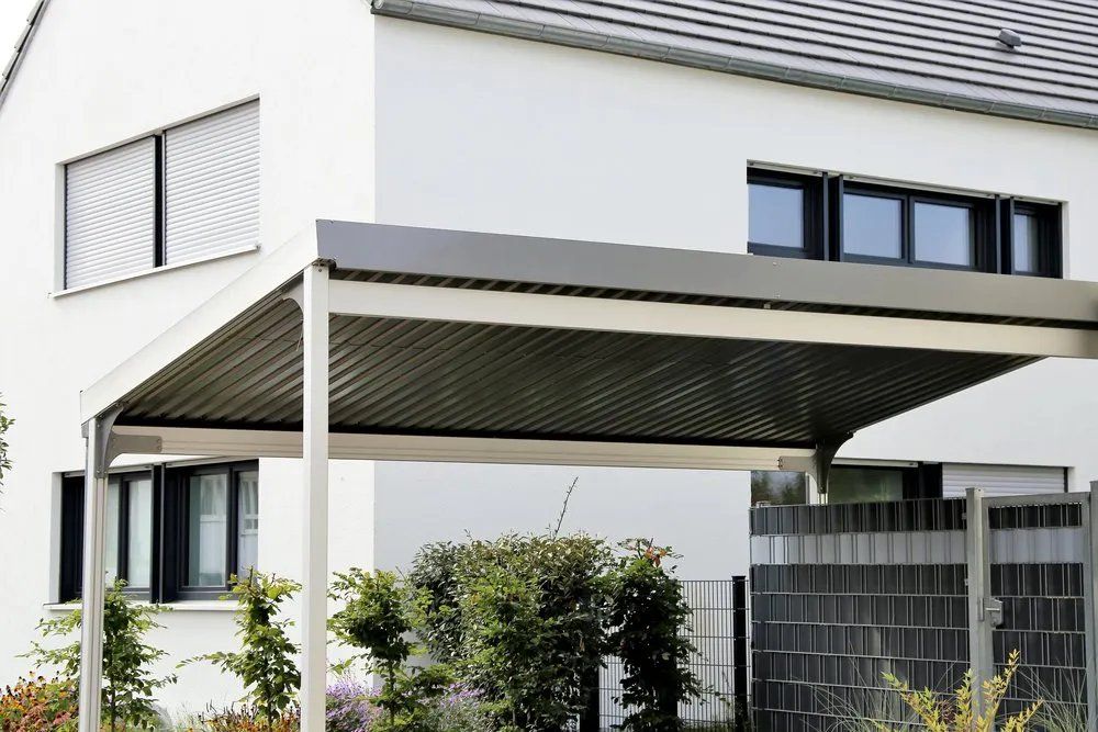 A White House with A Carport in Front of It — Manning Valley Patios in Harrington, NSW