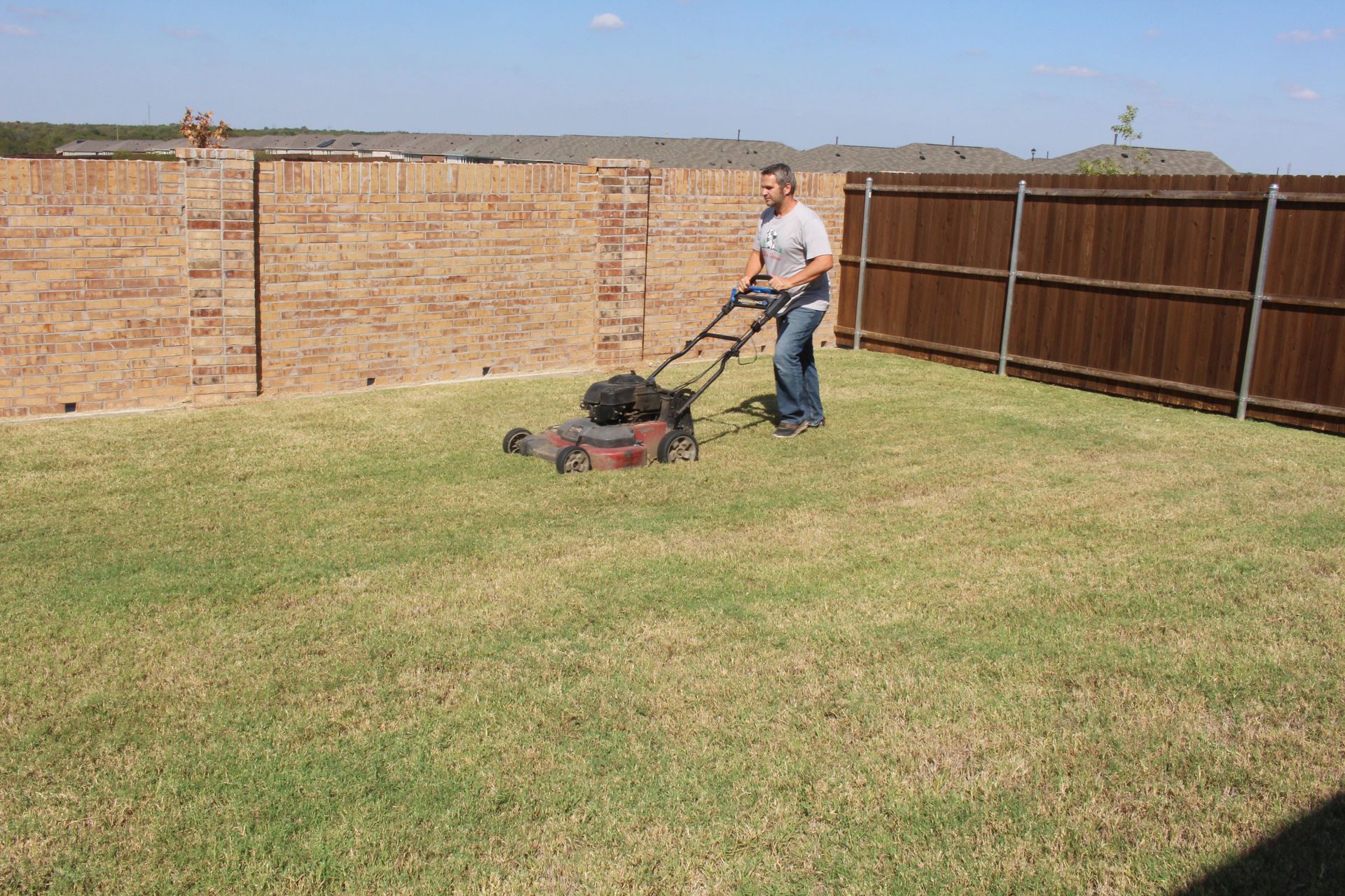 A man using lawn mower.