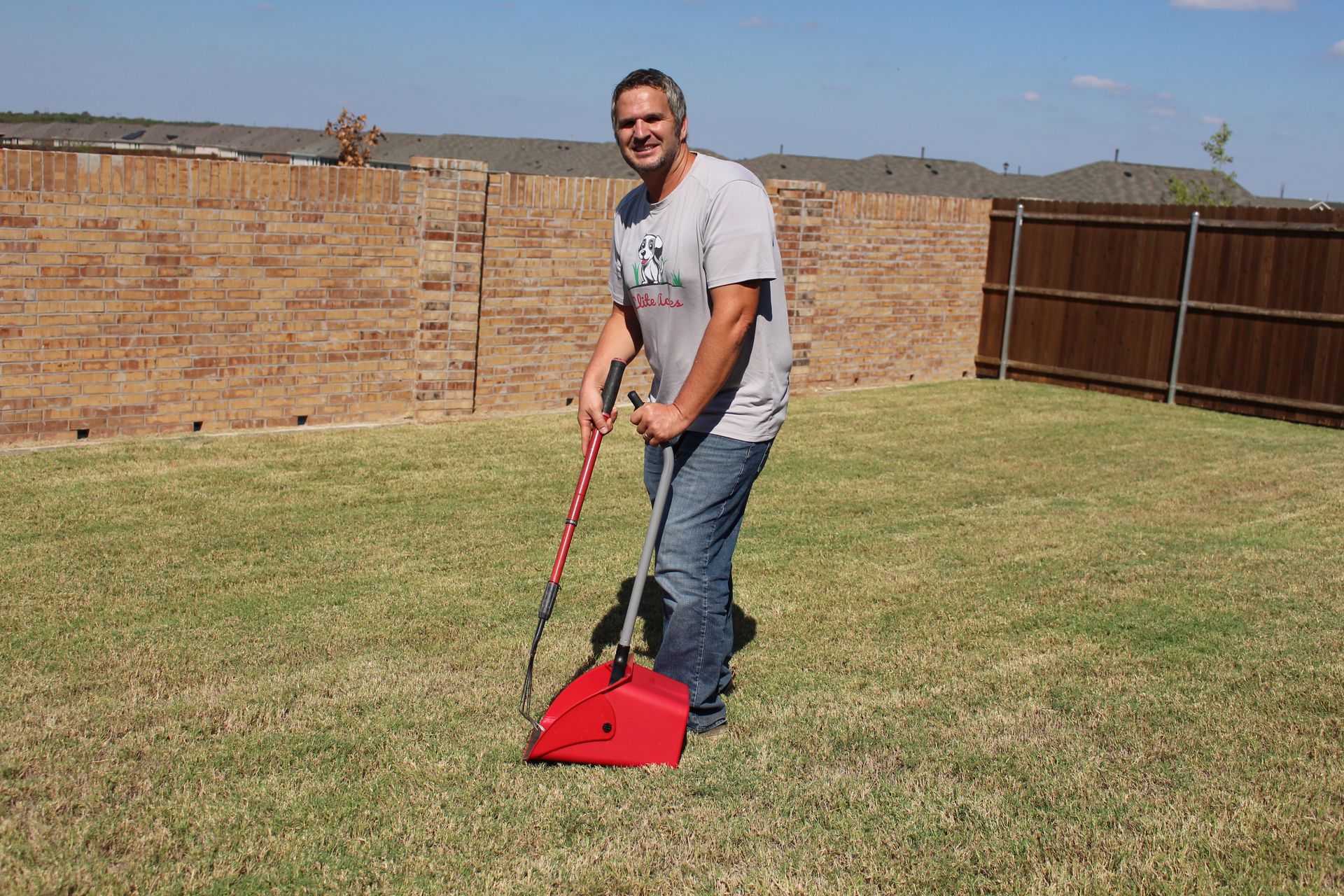 A man picking-up the dry leaves.